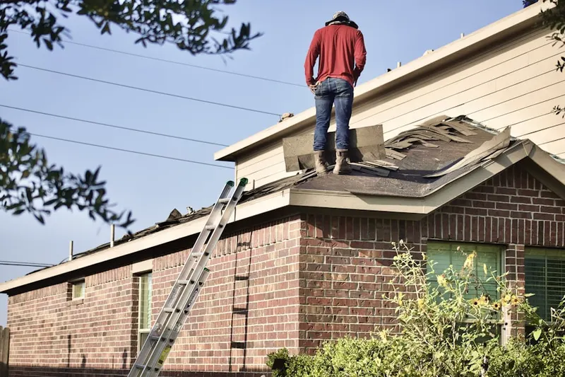 Professional roofer working on a residential roof in Princeton Colonial Park